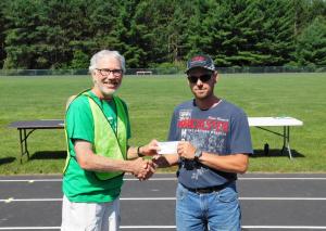 Mike Hopkins of H & S Excavating, LLC of Bruce, presents the Village President with a $750 check to go towards new Bruce Park Playground Equipment.